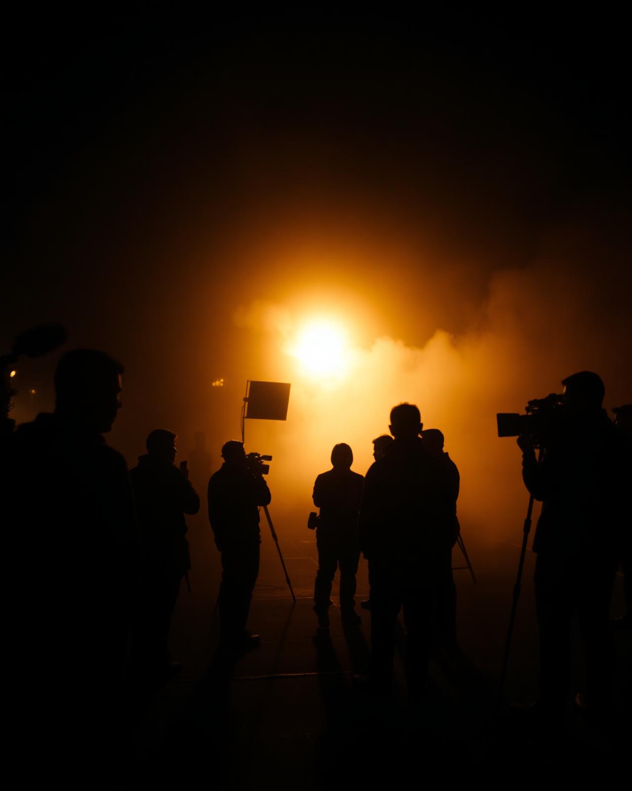 Film crew silhouetted on a night shoot