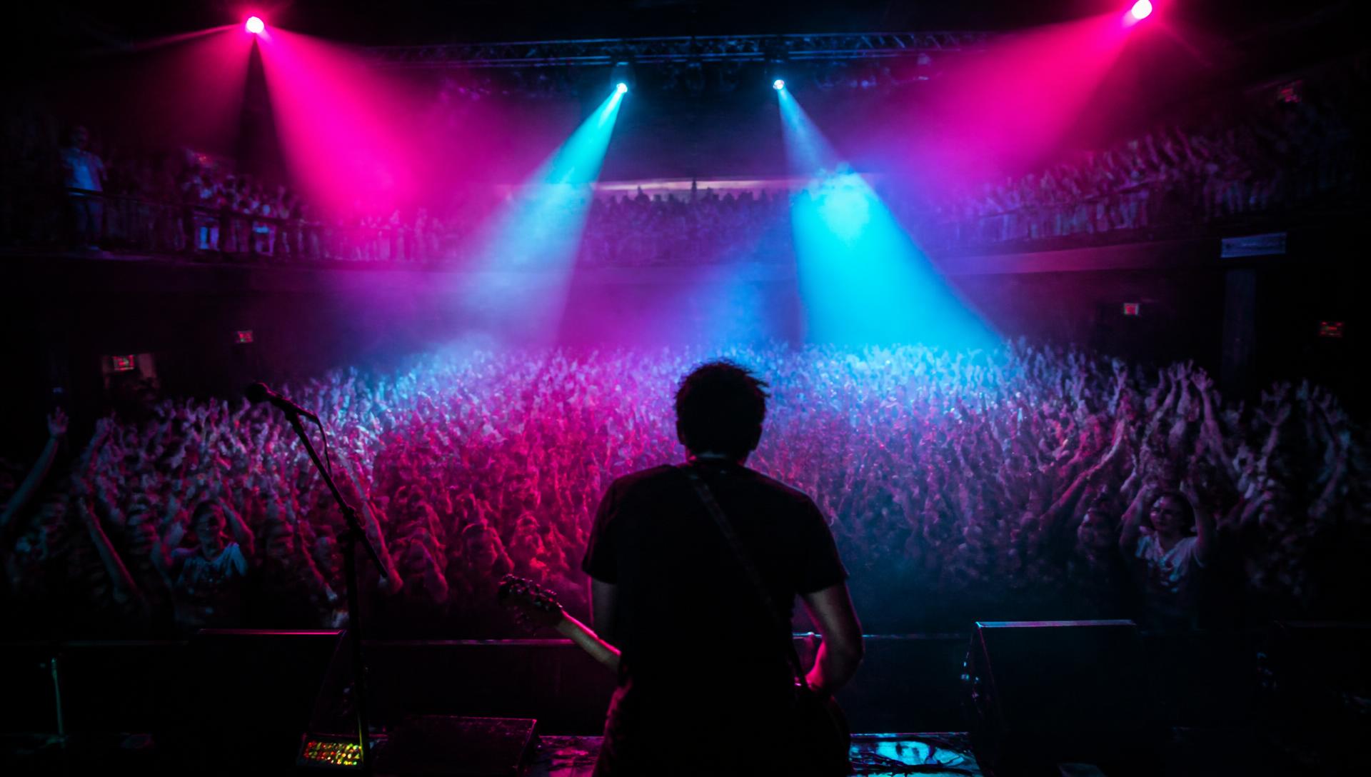 Concert crowd lit by stage beams